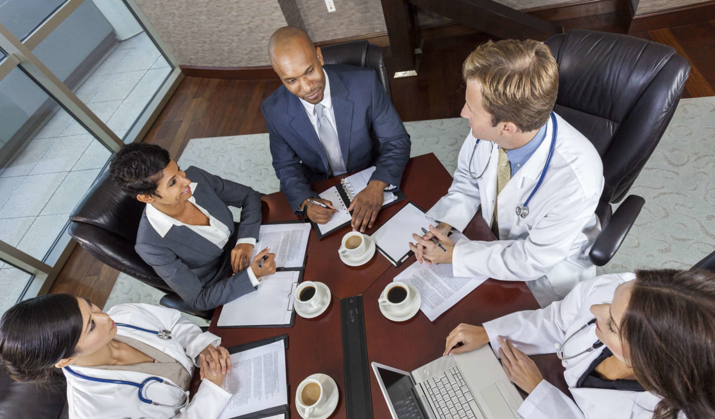 Top view of healthcare professionals and administrators in an morning meeting.