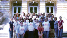 Group of legacy students and their family pose for a group photo on the steps of the conservatory of music.