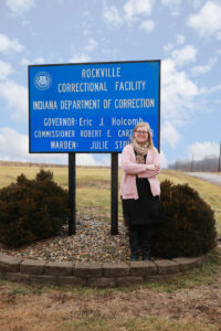 Henson standing in front of Rockville Correctional Facility sign