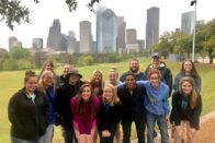 Group photo in front of the Houston skyline