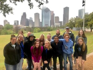 Group photo in front of the Houston skyline