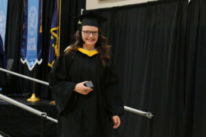 Stout walking down from the stage carrying her award