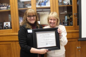 Hopper and President King holding the award