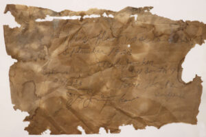 A faded brown paper with the builder's note