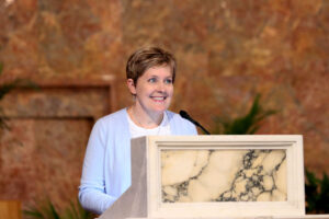 Clark at the podium of the church