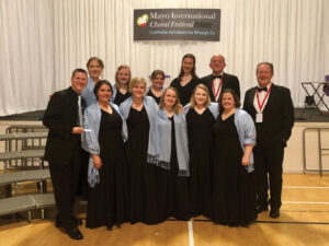 Madrigals standing on stage for a picture.