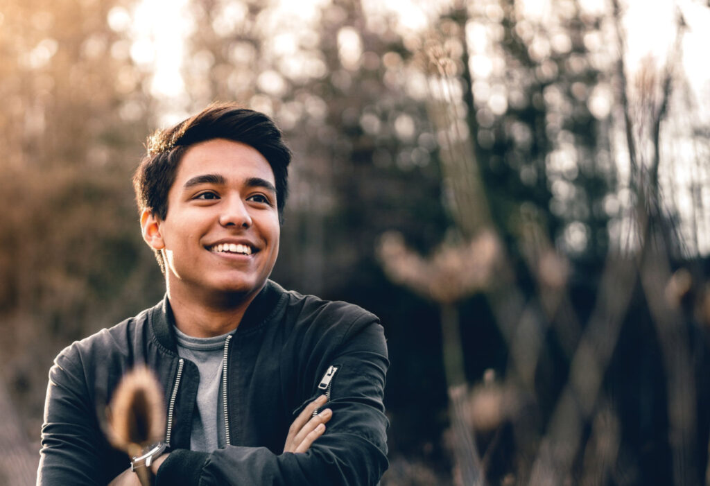 Smiling student outdoors in woods