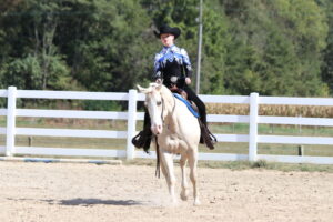 Carly Miller riding a horse in the arena