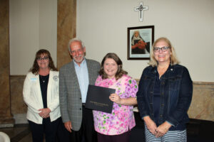 Catherine Larson accepting her scholarship certificate