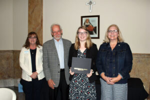 Autumn Wilson accepting her scholarship certificate