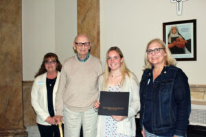 Sophia Ricard accepting her scholarship certificate