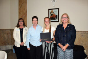 Kaileigh Pruitt accepting her scholarship certificate