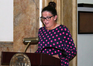 Mannah Mace speaking at the podium