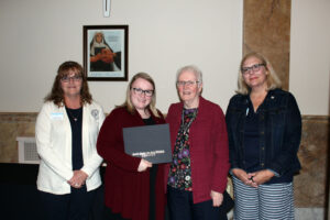 Sara Langenberger accepting her scholarship certificate