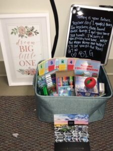 Basket of teacher themed gifts with a note
