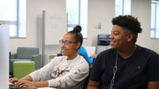 Student tutor helping someone in the LRC