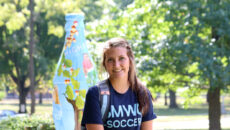 Smiling student in front of Rooney Library