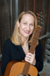 Tracy Richardson, Ph.D., MT-BC with guitar