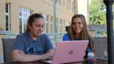 Students studying out on the Le Fer porch