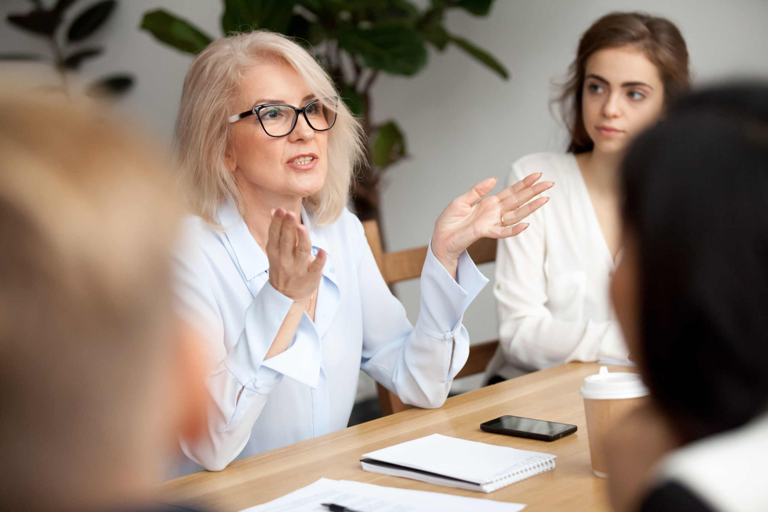 older woman speaking in group meeting