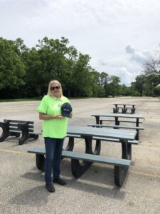 Kathy Kinney standing in front of the benches