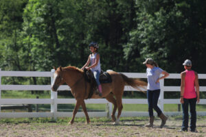 Schultz and Meehan following a camper on a horse