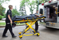 Paramedics taking a patient to an ambulance
