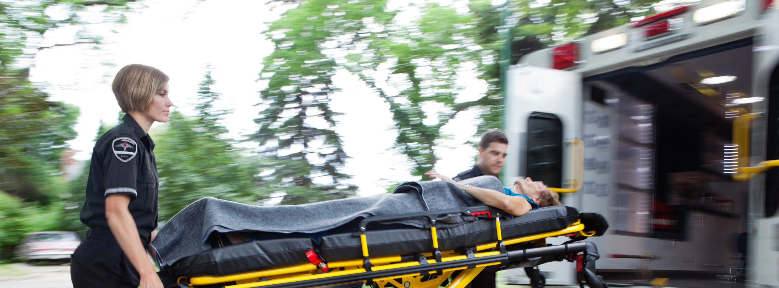 Paramedics taking a patient to an ambulance