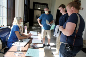 A family talking with a staff member at a booth