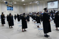 Graduates standing at commencement