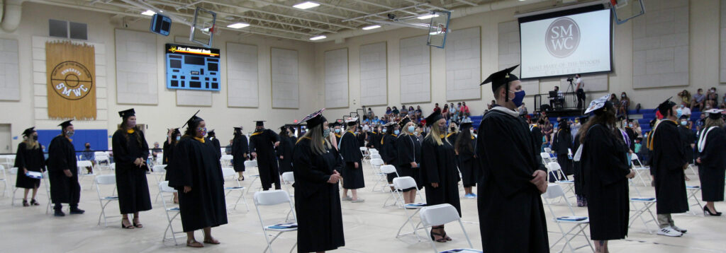 Graduates standing at commencement