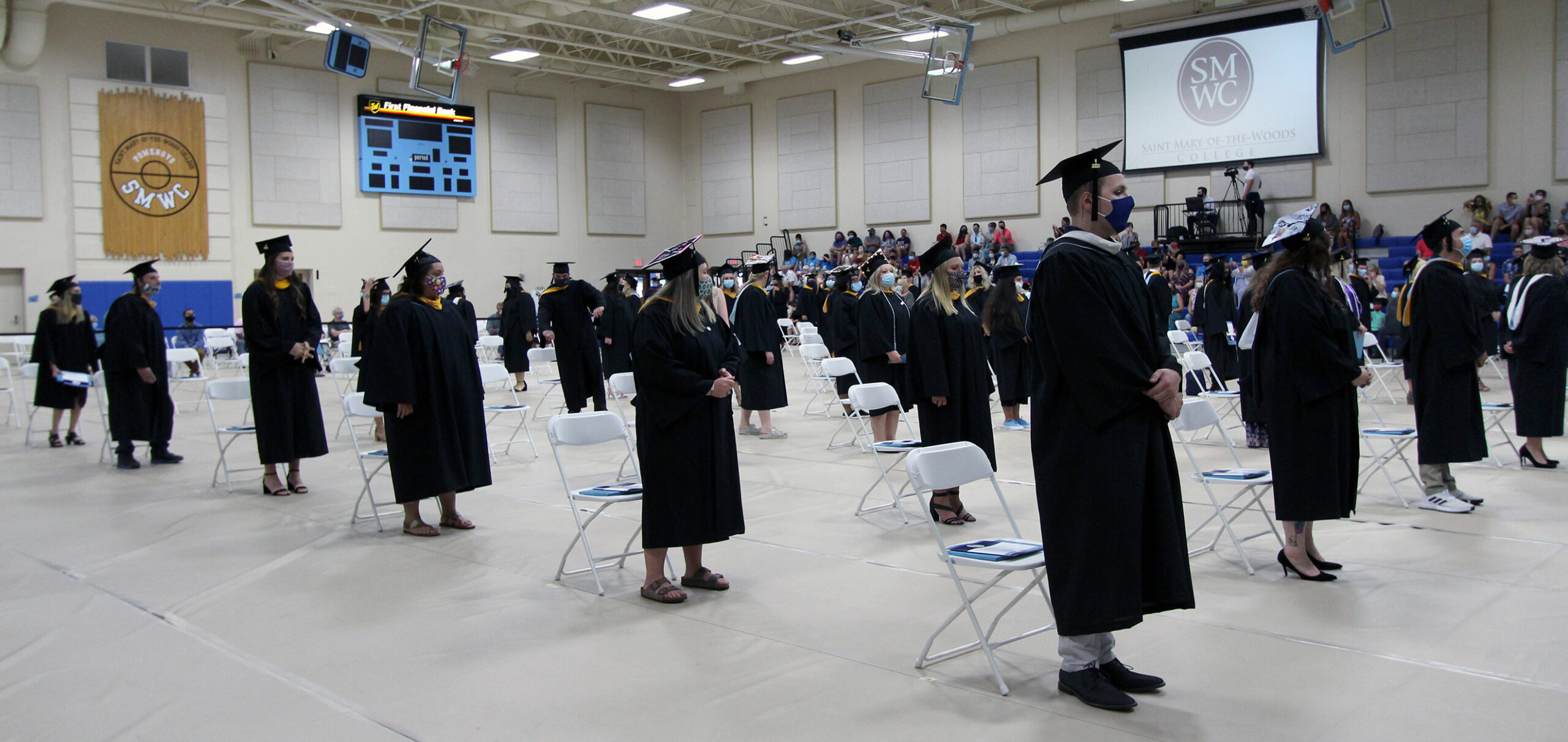 Graduates standing at commencement