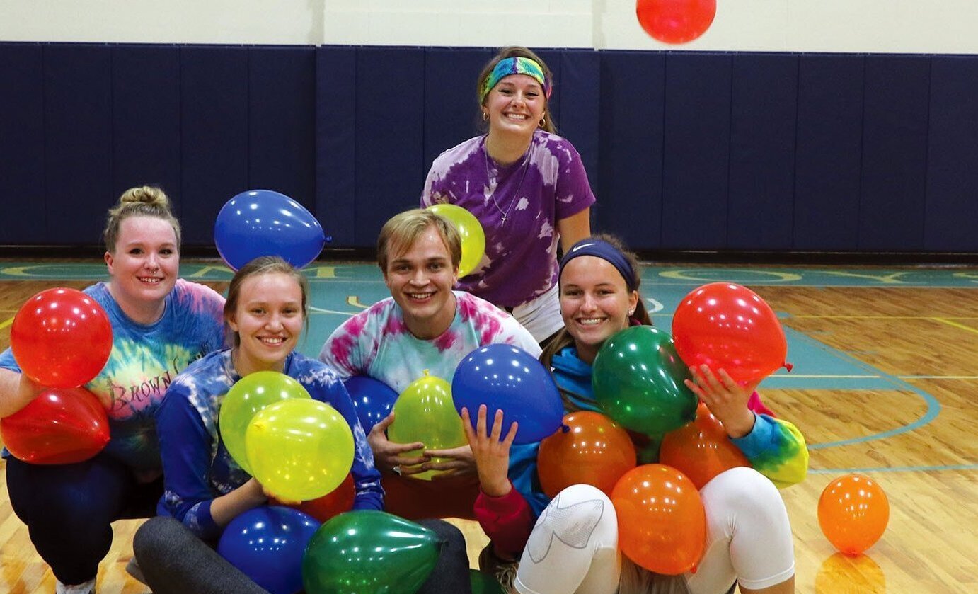 Students playing balloon game in the gym