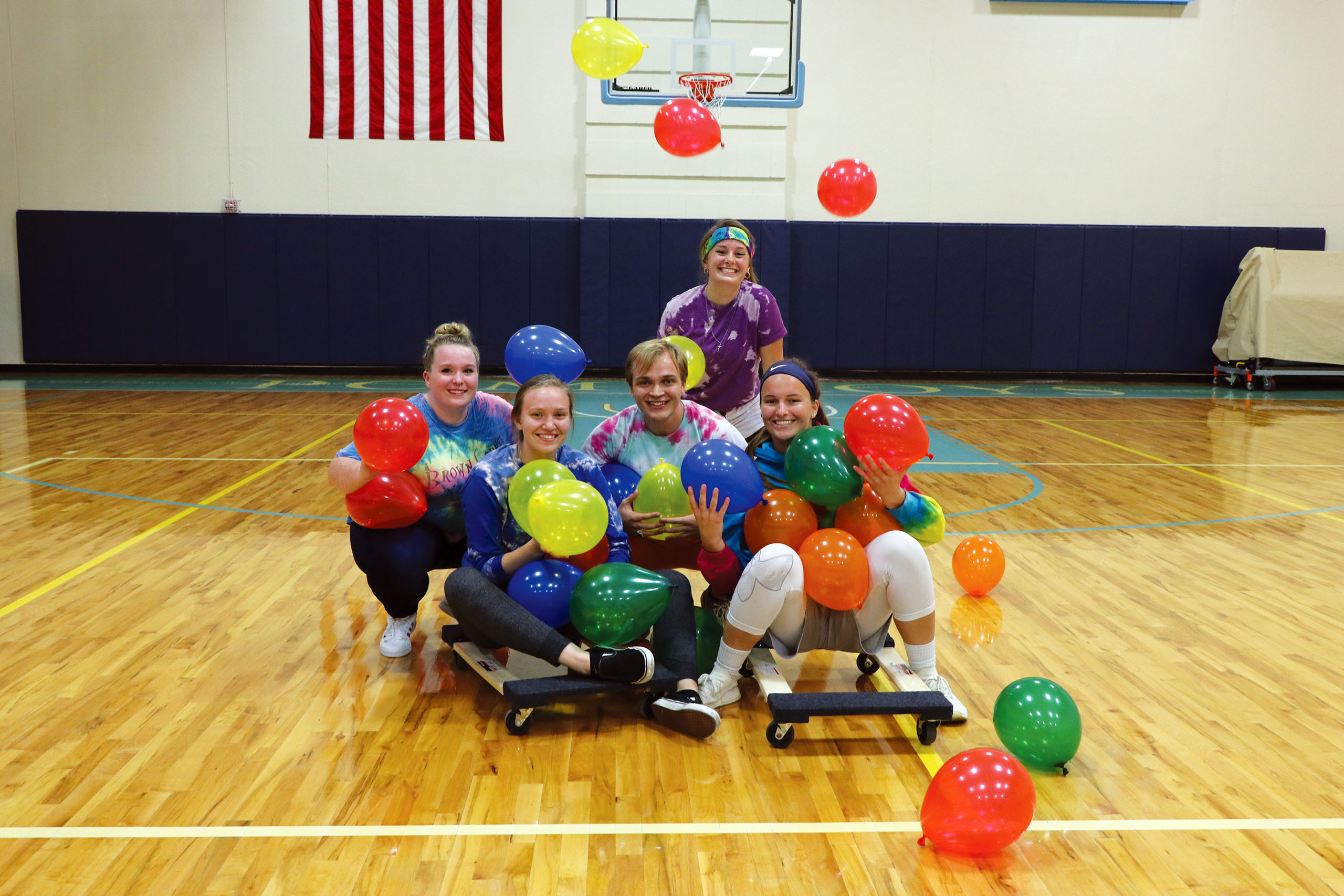 Students playing balloon game in the gym