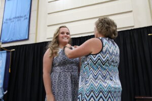 Nobbe being pinned by her mother at the ceremony