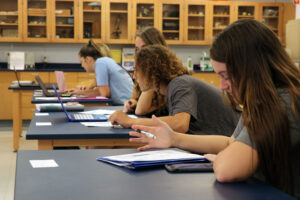 Science Students looking at and taking notes