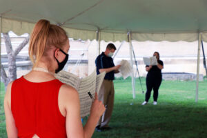 Students singing in classroom tent