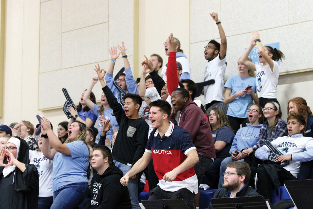 the fan section cheering at a basketball game