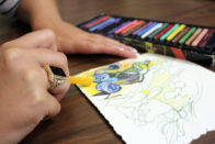 Art therapy student coloring with pastels