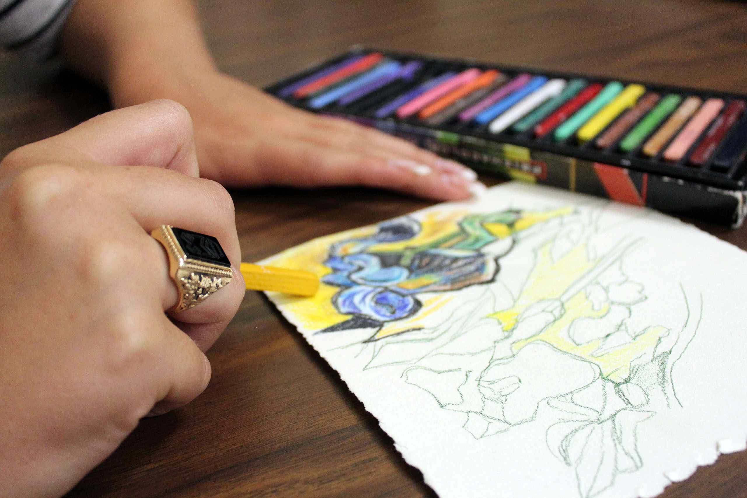 Art therapy student coloring with pastels