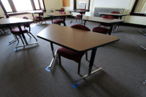 Physically distanced desks marked with tape