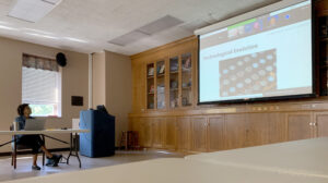 Reed watching the women's conference on a screen