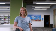 Kaci Jones standing and smiling in the Learning Resource Center