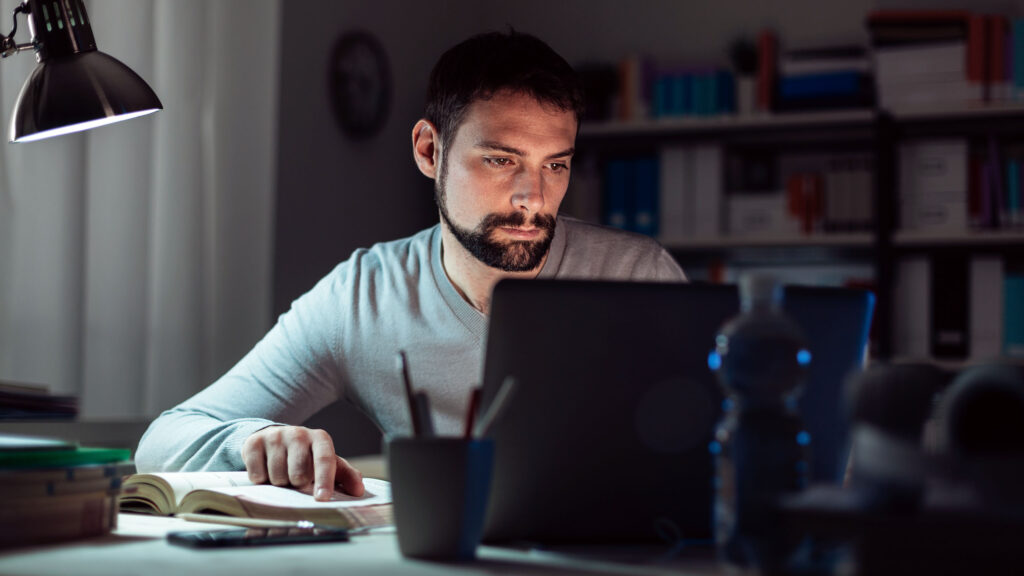 A man sitting at his desk studying