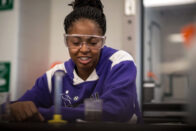 Student sitting with test tube in front of them