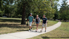 Students walking down a sidewalk on campus