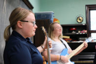 Two students playing guitar