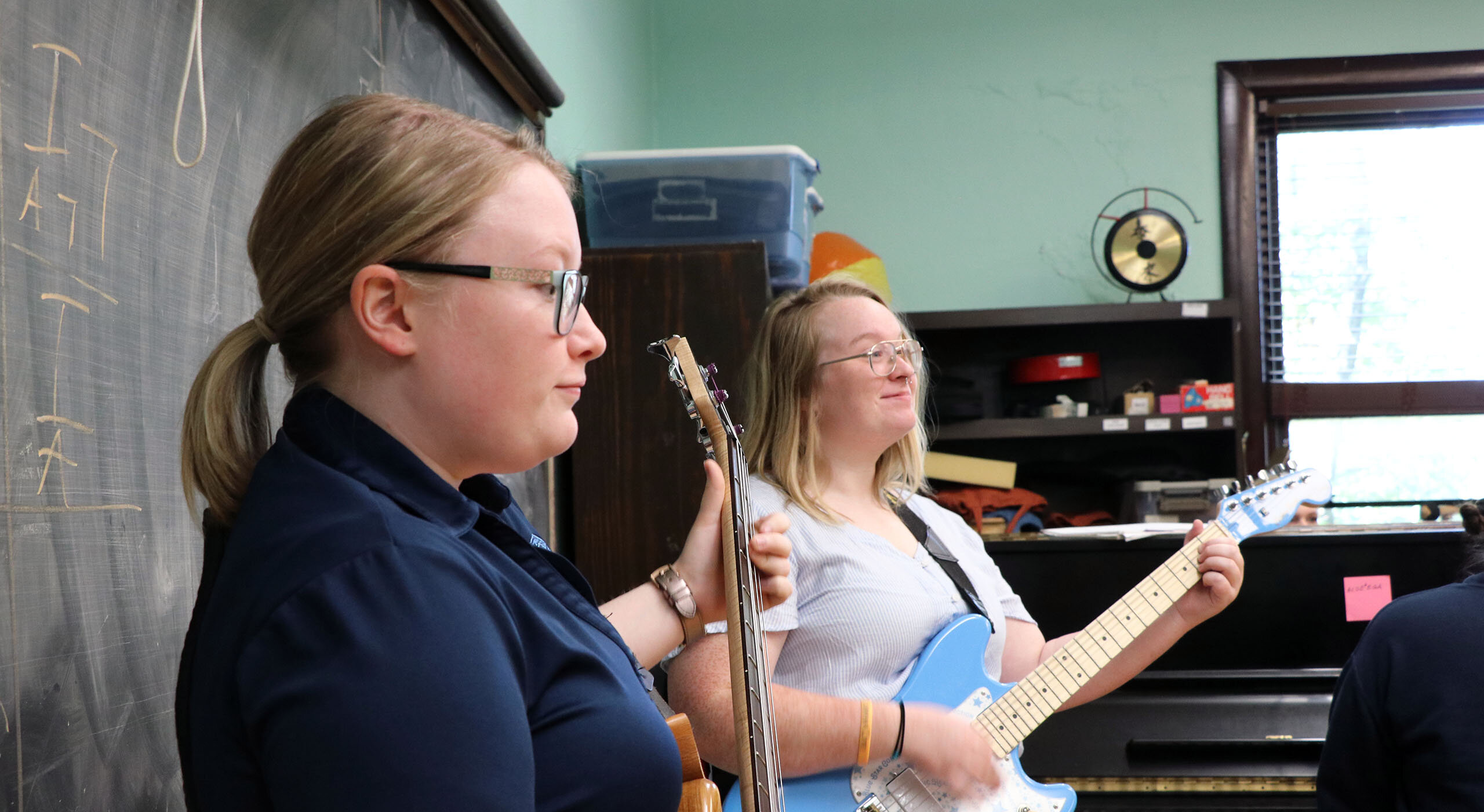 Two students playing guitar