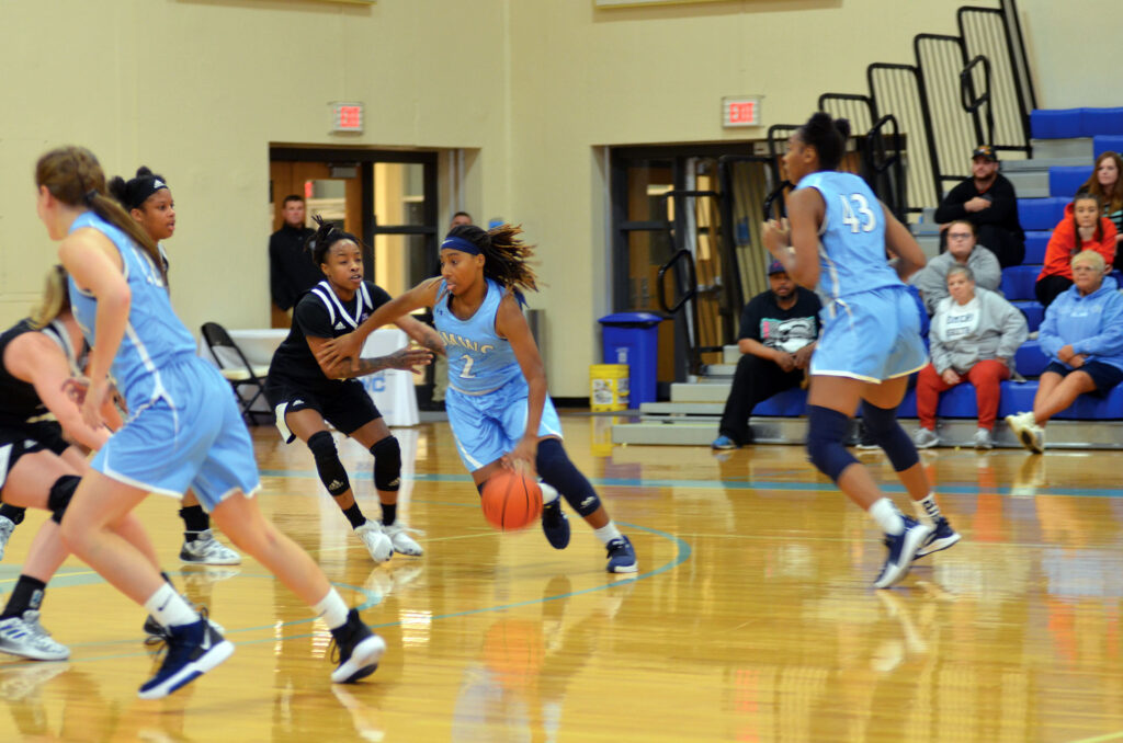 Women's basketball team playing against opponents