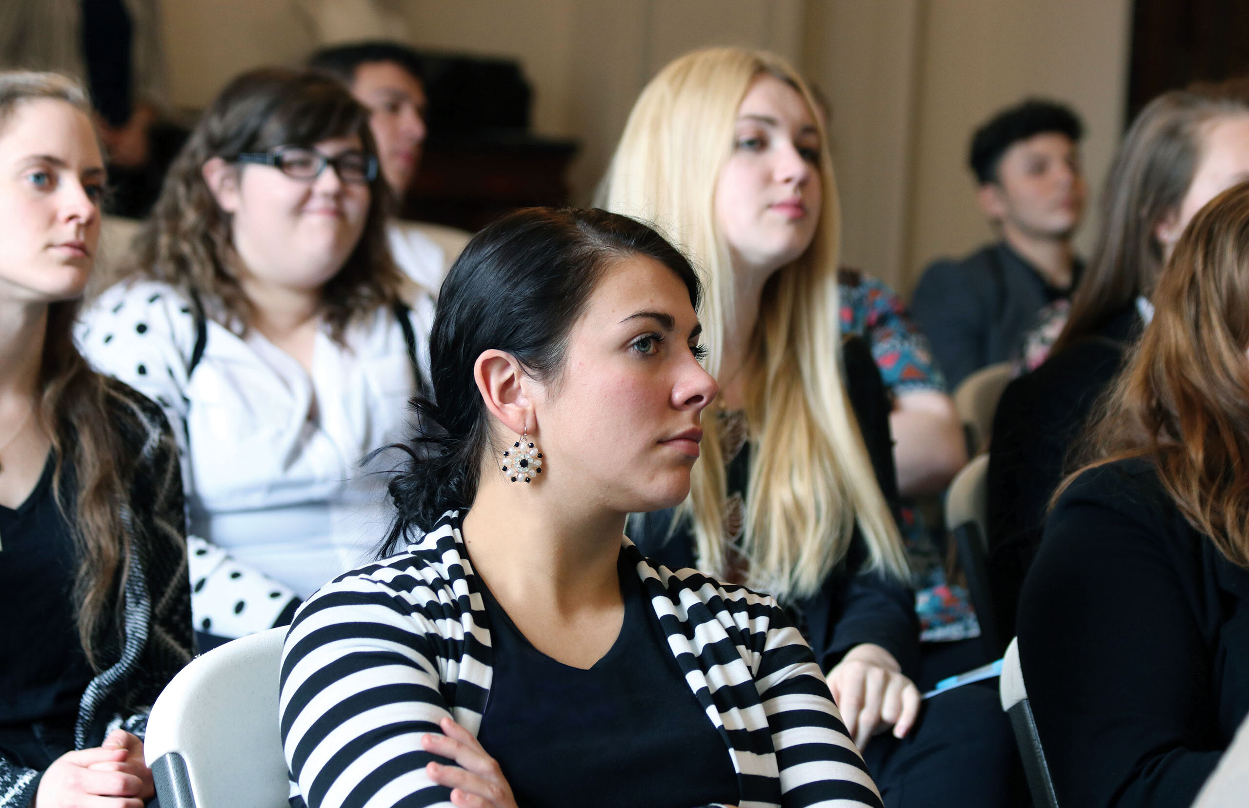 A group of students listening